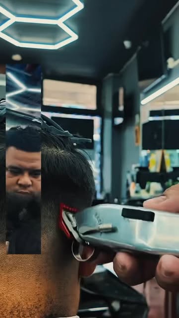 Barber detailing a fade with clippers