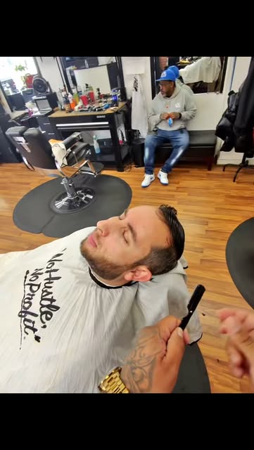Barber refining a haircut at the chair